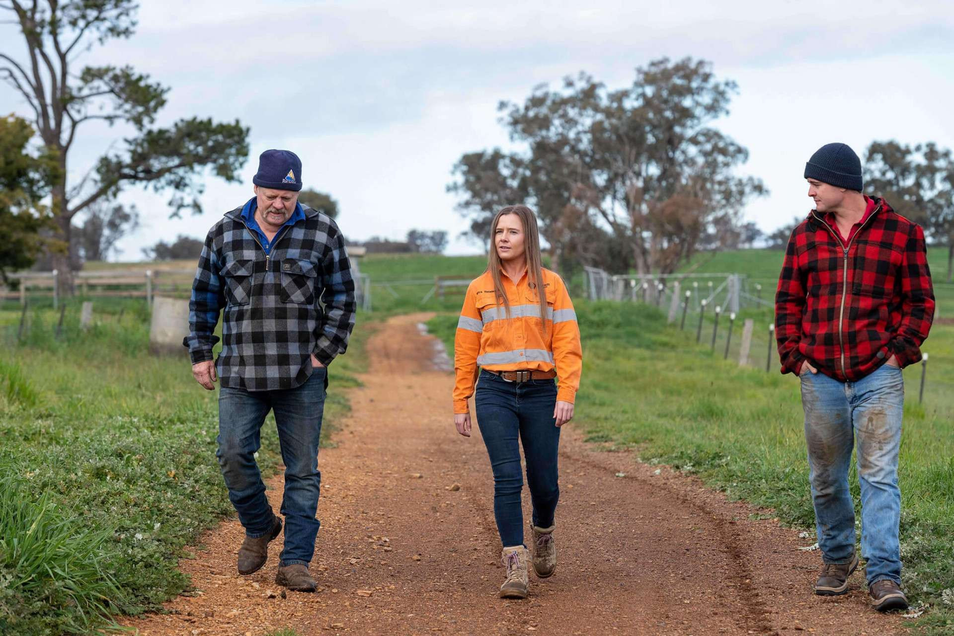 Two men and women walking on dirt path in Australia