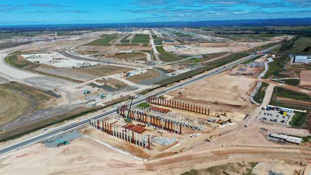 M12 aerial view over Airport and Eliz Dr piles