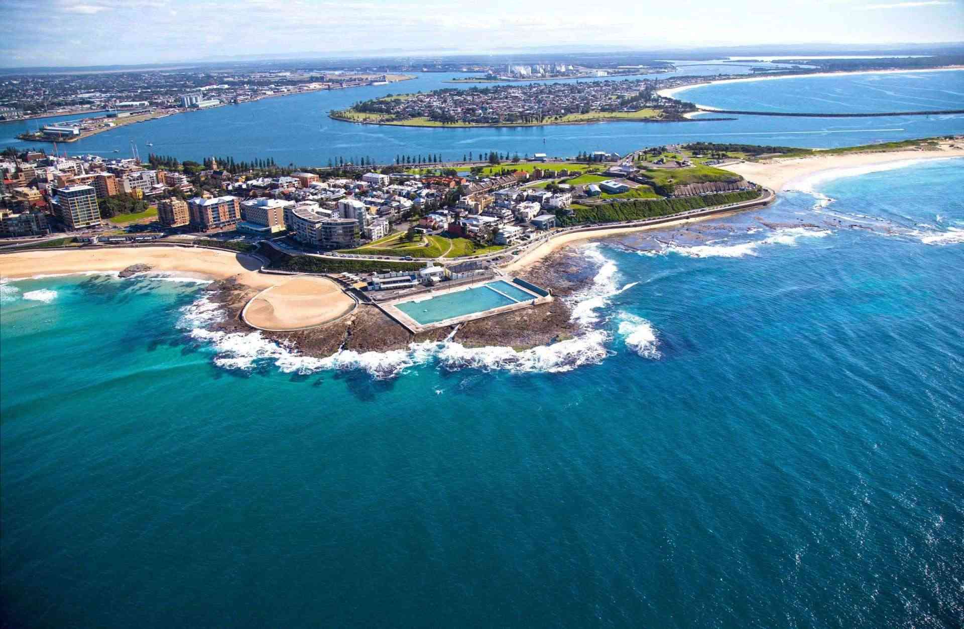 Aerial photo of a NSW beach pool and river inlet behind